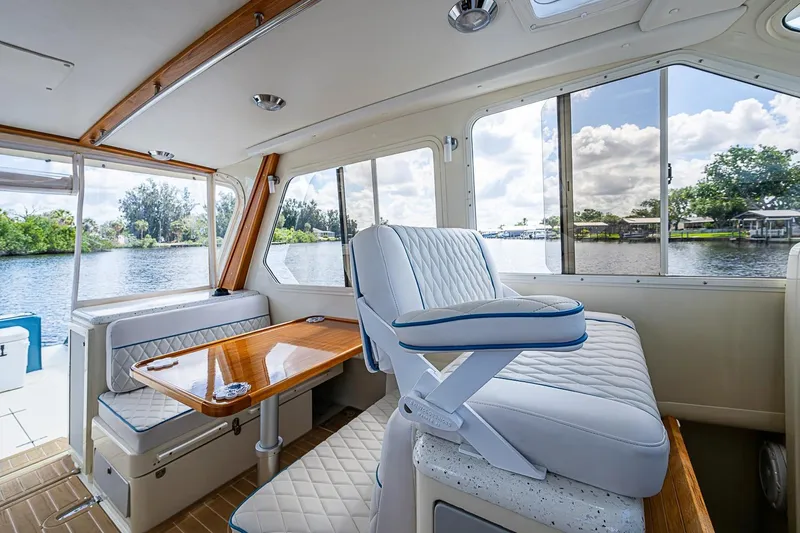 Slide: The Image of Interior of 2002 True North 38 boat with plush seating and scenic water view. - 24