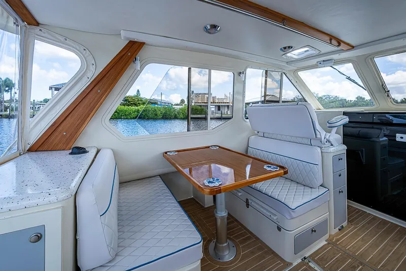 Slide: The Image of Luxurious interior of 2002 True North 38 yacht with elegant seating and scenic water views. - 25