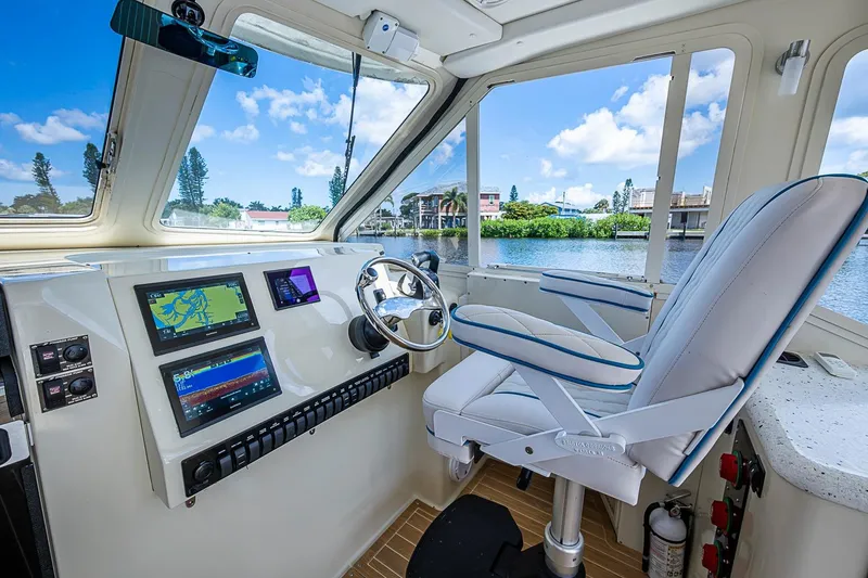Slide: The Image of Helm of 2002 True North 38 boat with navigation screens and captain's chair. - 27