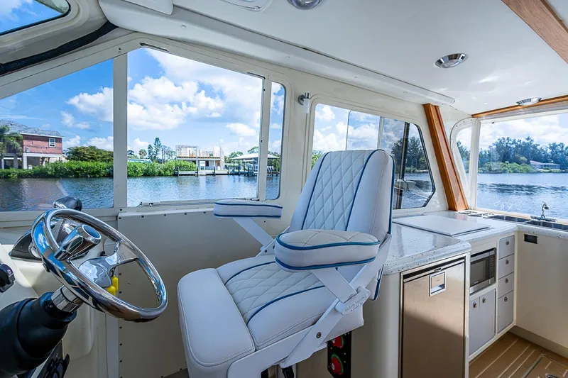 Slide: The Image of Interior of 2002 True North 38 boat with steering wheel and luxurious seating. - 28