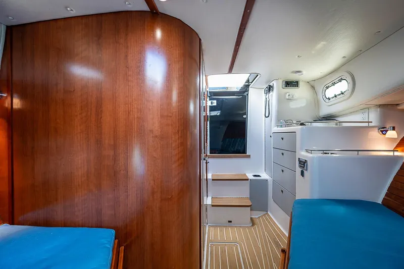 Slide: The Image of Interior of 2002 True North 38 yacht with wooden paneling and blue seating. - 29