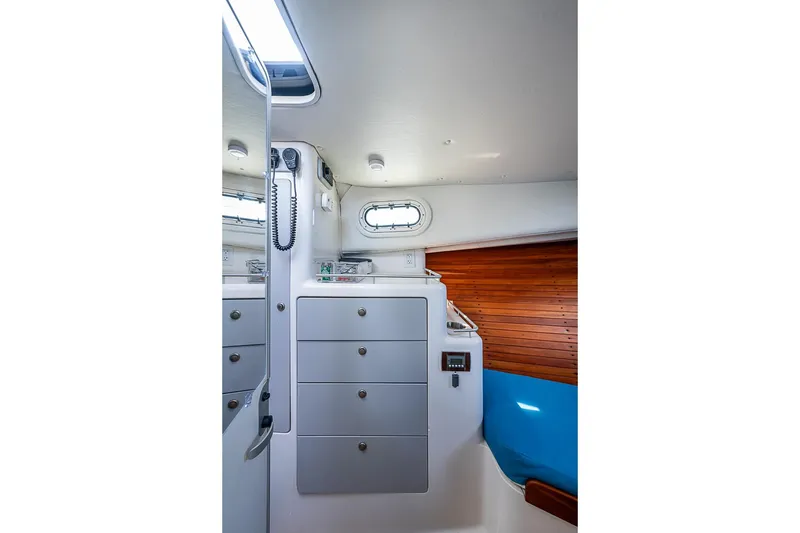 Slide: The Image of Interior of 2002 True North 38 boat with storage drawers and wooden paneling. - 31