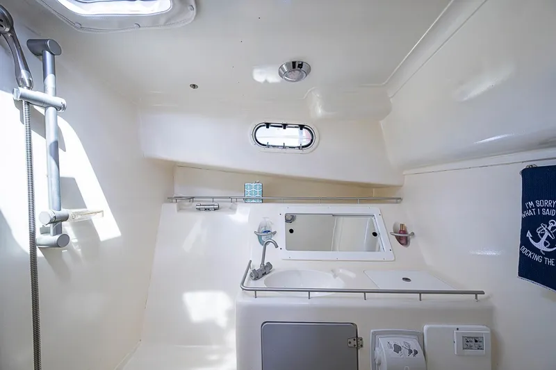 Slide: The Image of Interior of 2002 True North 38 yacht bathroom with shower and porthole window. - 33