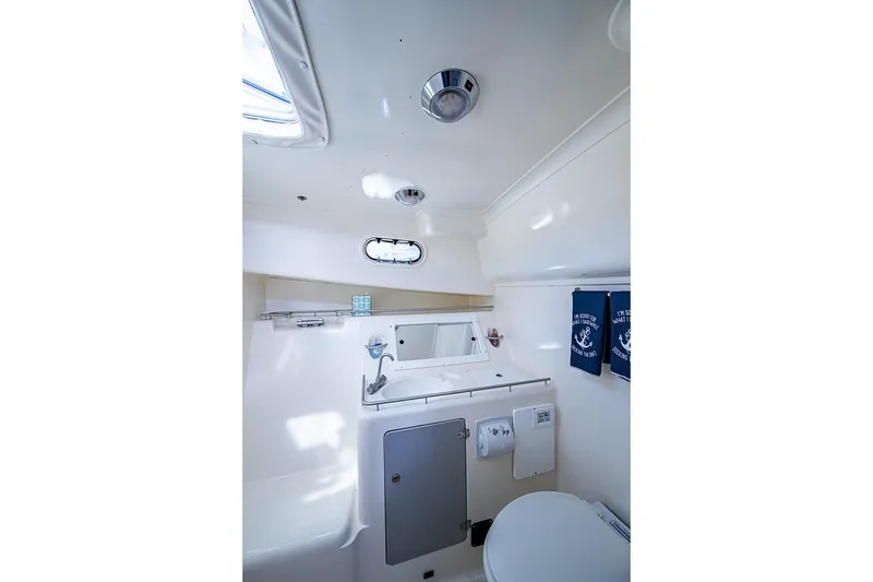 Slide: The Image of Compact bathroom in 2002 True North 38 yacht, featuring a toilet, sink, and nautical decor. - 34