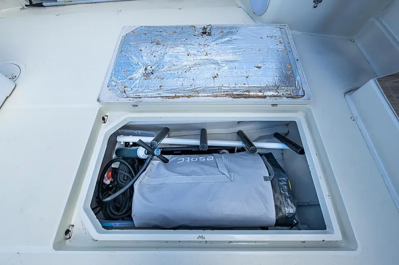 Slide: The Image of Storage compartment on a 2002 True North 38 boat, containing equipment and cables. - 36