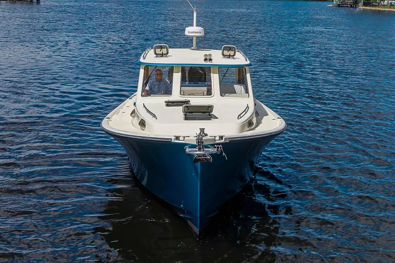 Slide: The Image of 2002 True North 38 boat on water, front view with Garmin equipment. - 5