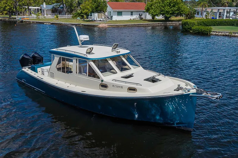 Slide: The Image of 2002 True North 38 boat cruising on a calm waterway. - 6