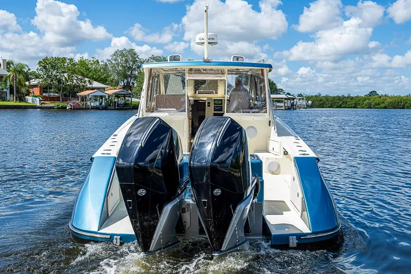 Slide: The Image of True North 38 boat from 2002 with dual outboard motors on a sunny day. - 8