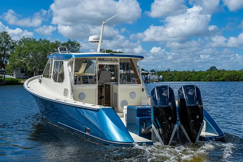 Slide: The Image of True North 38 boat from 2002 on a scenic waterway under a blue sky. - 9
