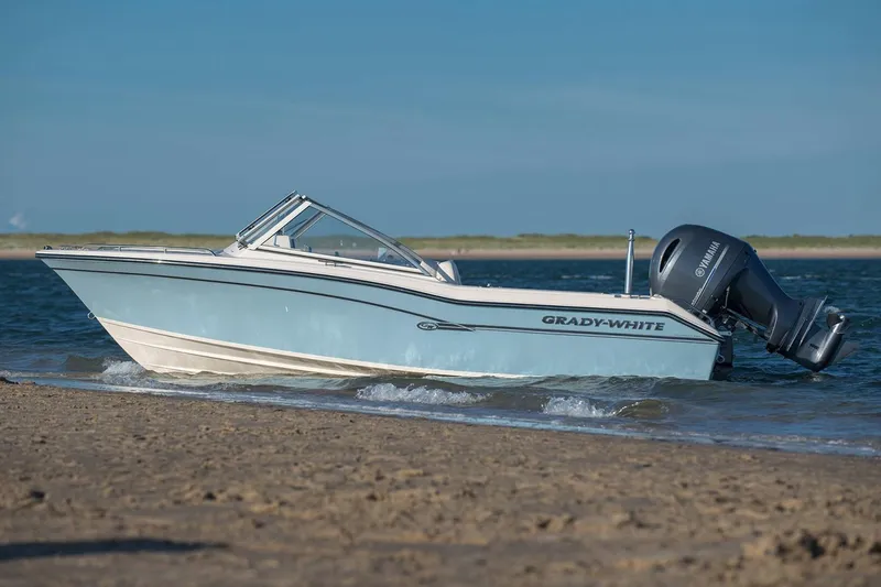 Slide: The Image of Manufacturer Provided Image: 2019 Grady-White Freedom 192 boat on sandy shore with Yamaha outboard motor. - 2