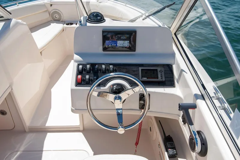 Slide: The Image of Manufacturer Provided Image: 2019 Grady-White Freedom 192 boat dashboard with steering wheel and navigation controls. - 6