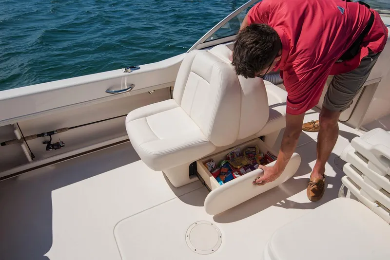 Slide: The Image of Manufacturer Provided Image: Man accessing storage under seat on 2019 Grady-White Freedom 192 boat. - 8