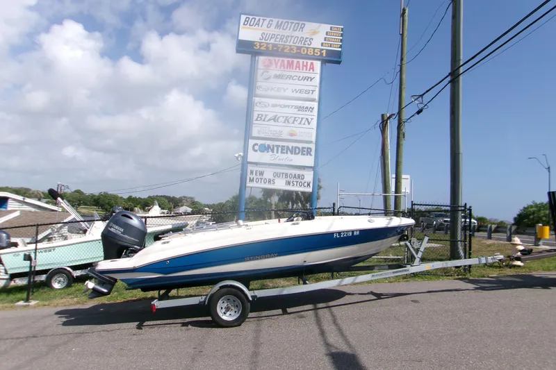 The Image of 2018 Stingray 182 SC boat on trailer near dealership sign. - 0