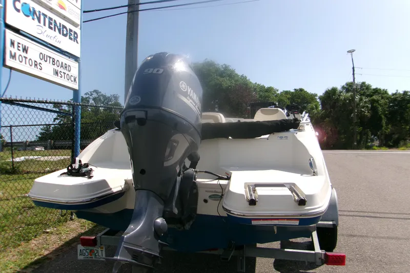 Slide: The Image of 2018 Stingray 182 SC boat with Yamaha 90 outboard motor, parked near dealership. - 3