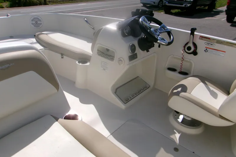 Slide: The Image of 2018 Stingray 182 SC boat interior with steering wheel and seating. - 6