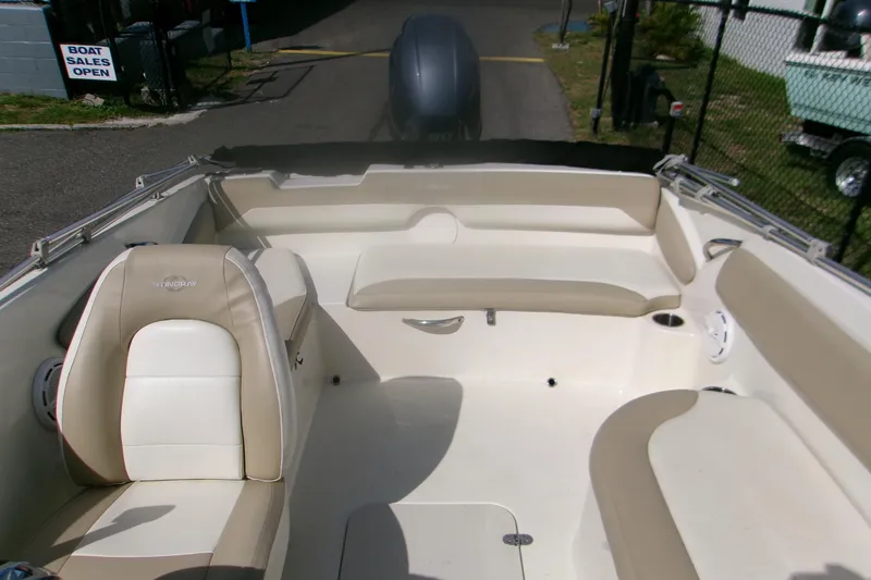 Slide: The Image of 2018 Stingray 182 SC boat interior with beige and white seating. - 8