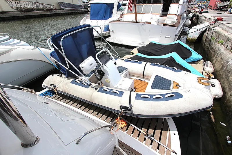 Slide: The Image of 2001 Sunseeker Predator 56 yacht docked with inflatable boat on deck. - 10