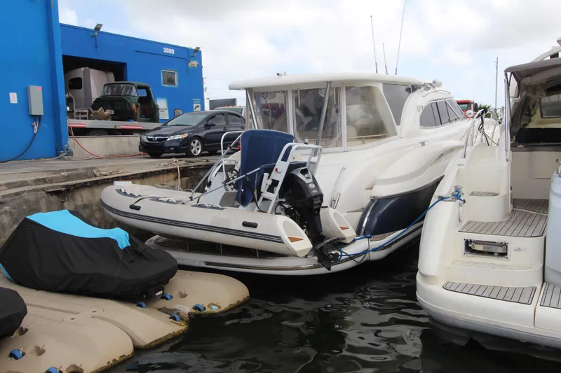 Slide: The Image of 2001 Sunseeker Predator 56 yacht docked with inflatable boat and outboard motor. - 4