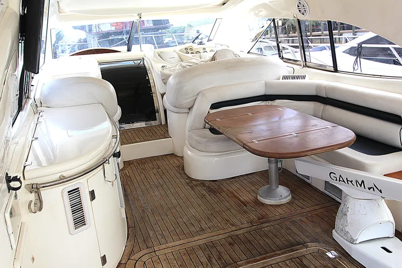 Slide: The Image of Luxurious interior of 2001 Sunseeker Predator 56 yacht with wooden table and seating. - 6