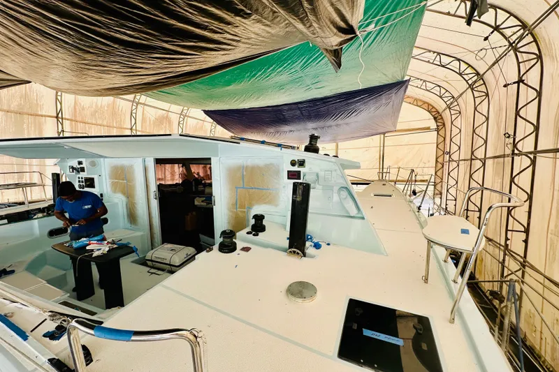 Slide: The Image of Worker refurbishing 2011 Alibi 54 yacht under protective canopy. - 11