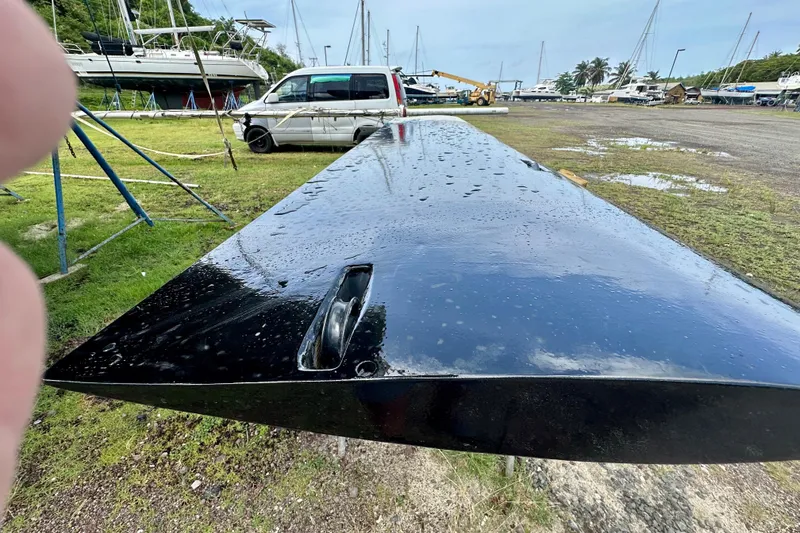 Slide: The Image of A wet, black boat keel from an Alibi 54, 2011, in a shipyard setting. - 15