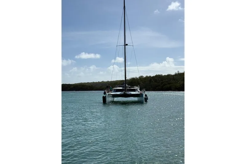 Slide: The Image of Catamaran Alibi 54 sailing in clear waters, 2011 model, under a sunny sky. - 17