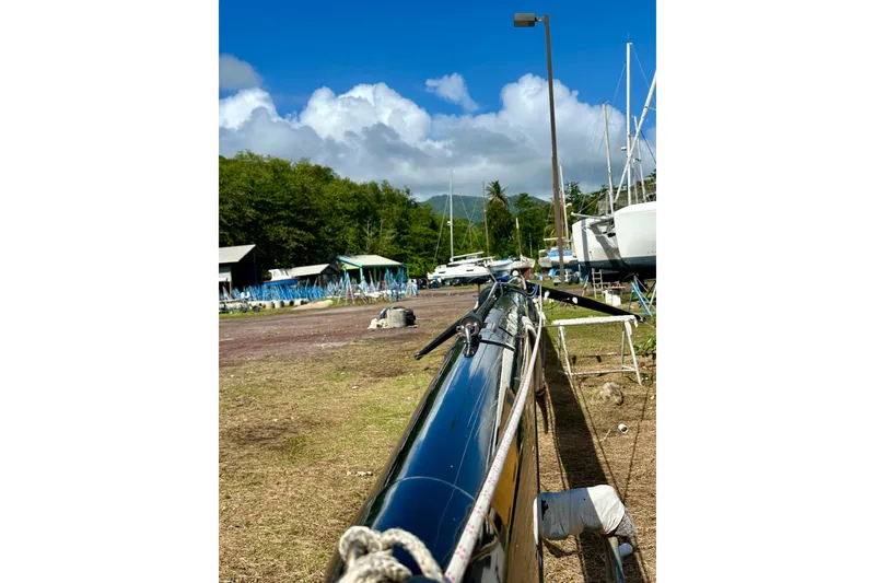 Slide: The Image of Sailboat mast in a boatyard with Alibi 54, 2011 model, under a clear blue sky. - 25