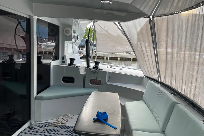 Slide: The Image of Interior of 2011 Alibi 54 boat with seating and table, dockside view. - 26