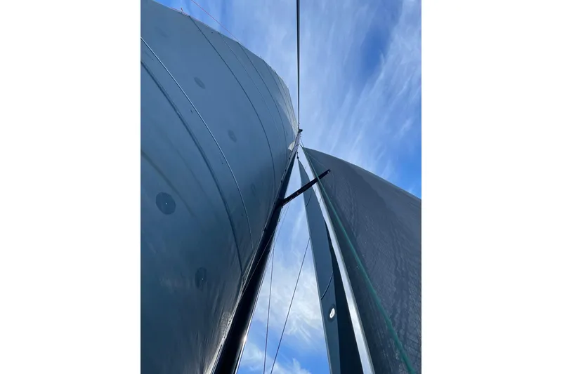 Slide: The Image of Looking up at the sails of a 2011 Alibi 54 catamaran against a blue sky. - 29