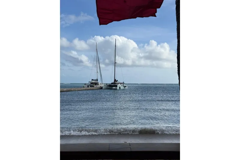 Slide: The Image of Sailboats anchored near a pier under a cloudy sky, Alibi 54, 2011 model. - 4
