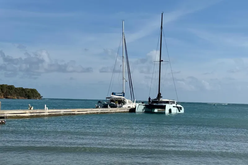 Slide: The Image of Two sailboats docked at a pier on a sunny day, Alibi 54 model, 2011. - 6