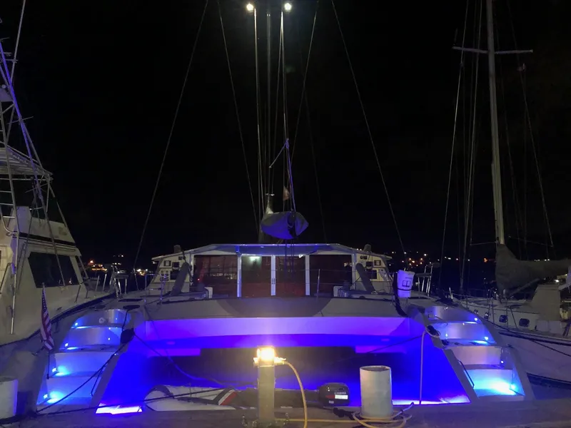 Slide: The Image of 2011 Alibi 54 yacht with blue lights docked at night. - 9