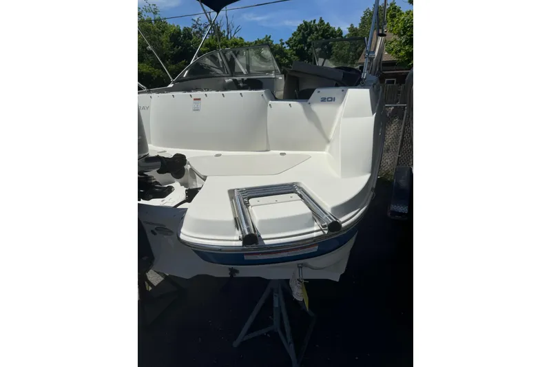 Slide: The Image of 2018 Stingray 201 DC boat, rear view with swim platform and ladder. - 11