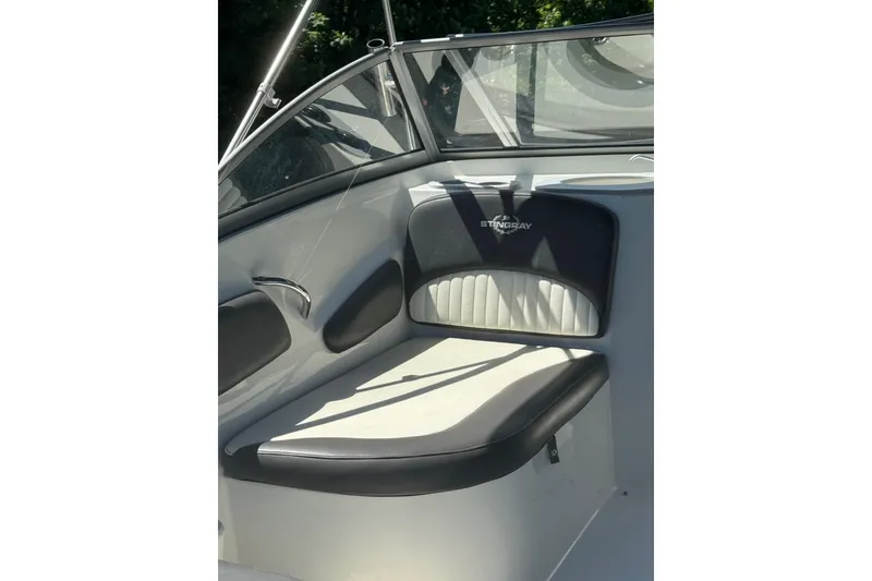 Slide: The Image of 2018 Stingray 201 DC boat interior with cushioned seating and sleek design. - 7