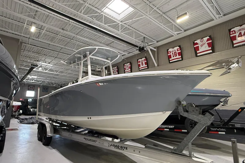 Slide: The Image of 2016 Sea Hunt Gamefish 25 boat on trailer in indoor showroom. - 1