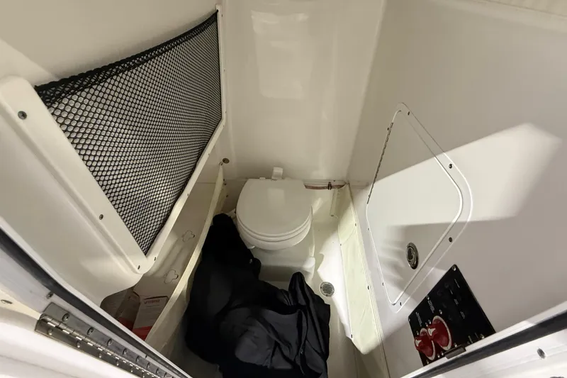 Slide: The Image of Interior of 2016 Sea Hunt Gamefish 25 boat with toilet and storage area. - 10