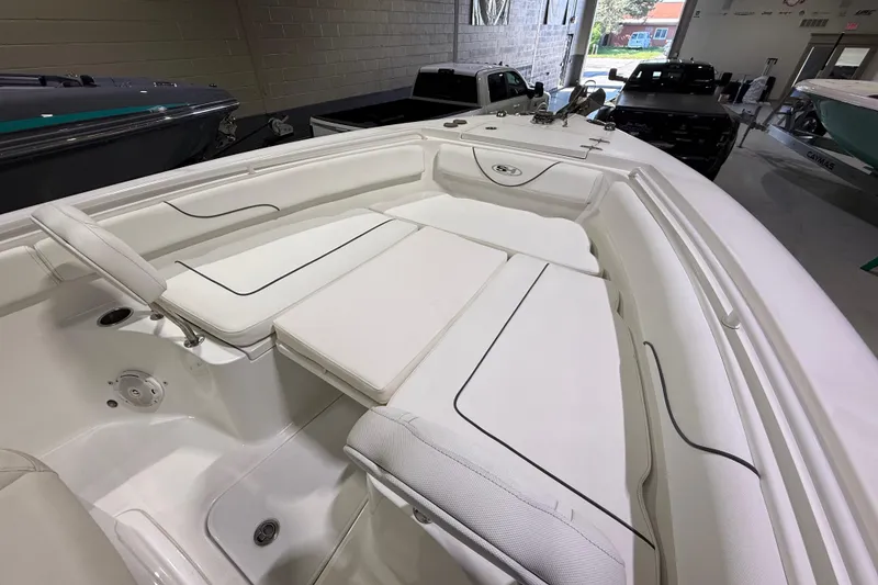 Slide: The Image of 2016 Sea Hunt Gamefish 25 boat interior with white cushioned seating. - 11
