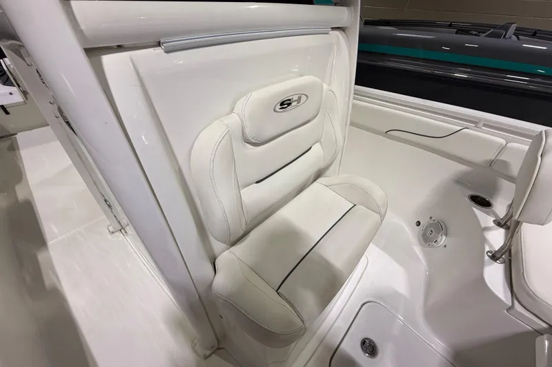 Slide: The Image of 2016 Sea Hunt Gamefish 25 boat interior with white cushioned seating. - 13