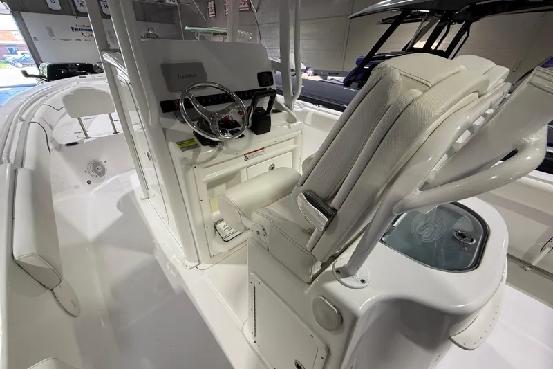 Slide: The Image of 2016 Sea Hunt Gamefish 25 boat interior with helm, seating, and navigation equipment. - 6