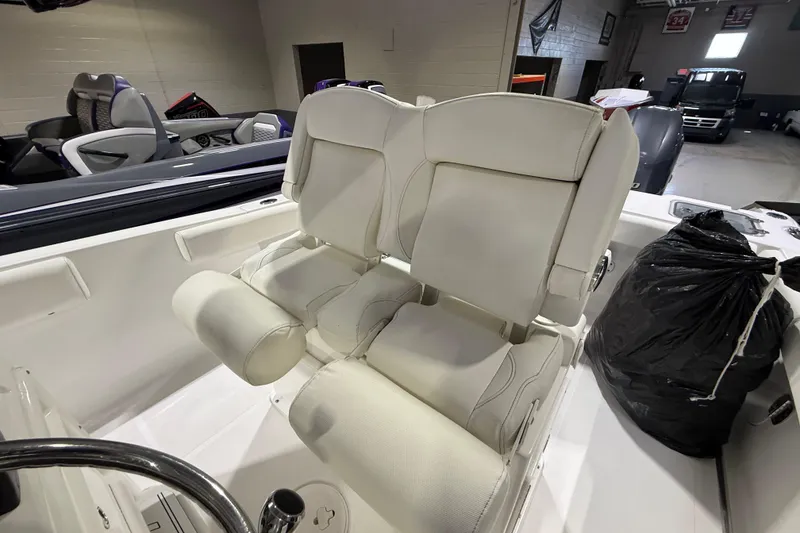 Slide: The Image of 2016 Sea Hunt Gamefish 25 boat interior with white cushioned seating. - 9