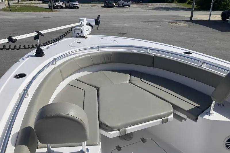 Slide: The Image of 2024 Sportsman Heritage 231 Center Console boat with cushioned seating and trolling motor. - 10