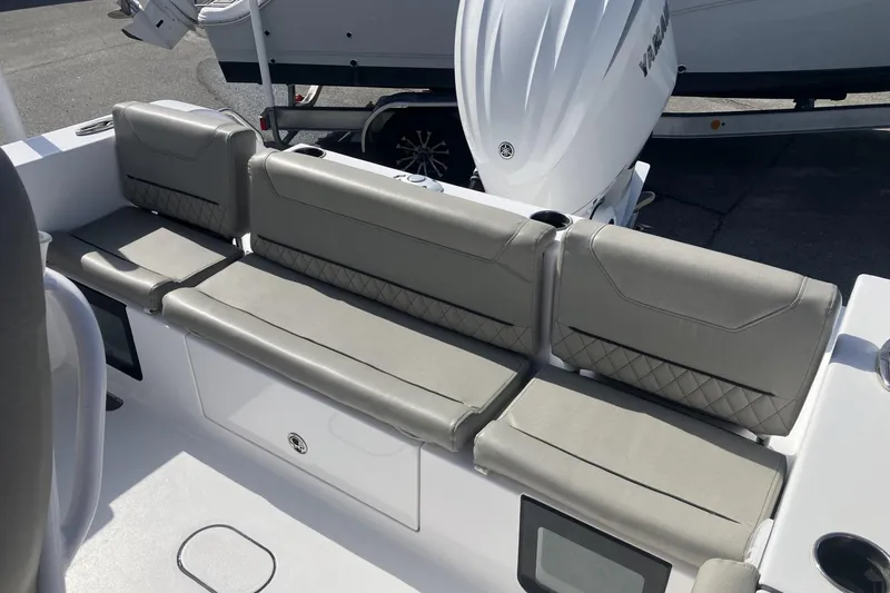Slide: The Image of 2024 Sportsman Heritage 231 Center Console boat seating with gray cushions and Yamaha engine. - 13