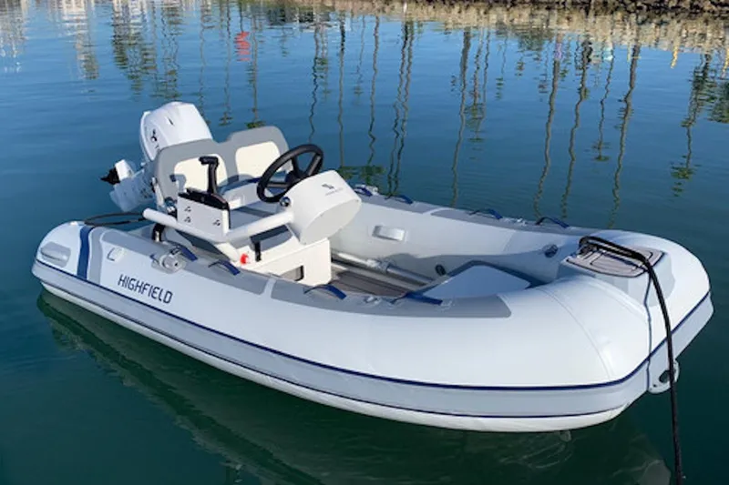The Image of 2025 Highfield Classic 360 FCT boat on calm water, showcasing sleek design and modern features. - 0