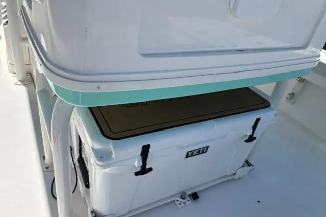 Slide: The Image of 2021 Caymas 26 HB boat with a Yeti cooler stored underneath a seat. - 10