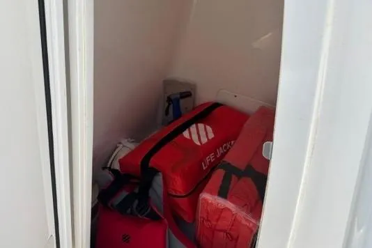 Slide: The Image of Storage compartment in 2021 Caymas 26 HB boat with life jackets. - 11