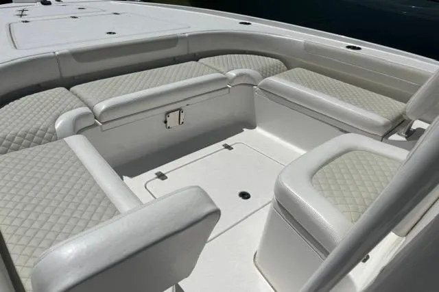 Slide: The Image of 2021 Caymas 26 HB boat interior with cushioned seating and storage compartments. - 13