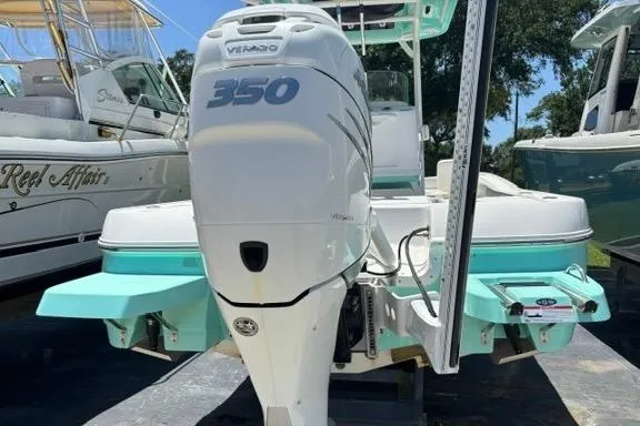Slide: The Image of 2021 Caymas 26 HB boat with 350 horsepower engine, docked outdoors. - 4