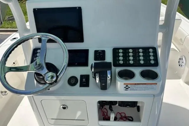 Slide: The Image of Control panel of 2021 Caymas 26 HB boat with steering wheel and electronic displays. - 6
