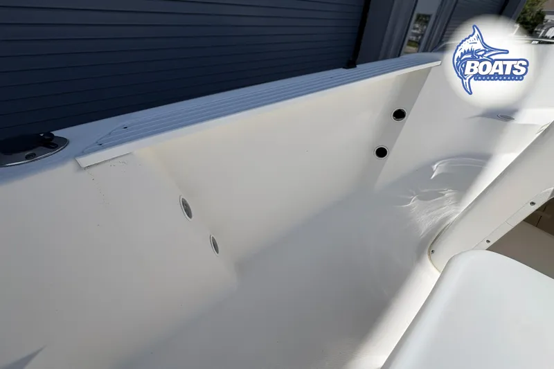 Slide: The Image of 2004 Wellcraft 180 Fisherman boat interior with logo, showcasing sleek white design. - 10