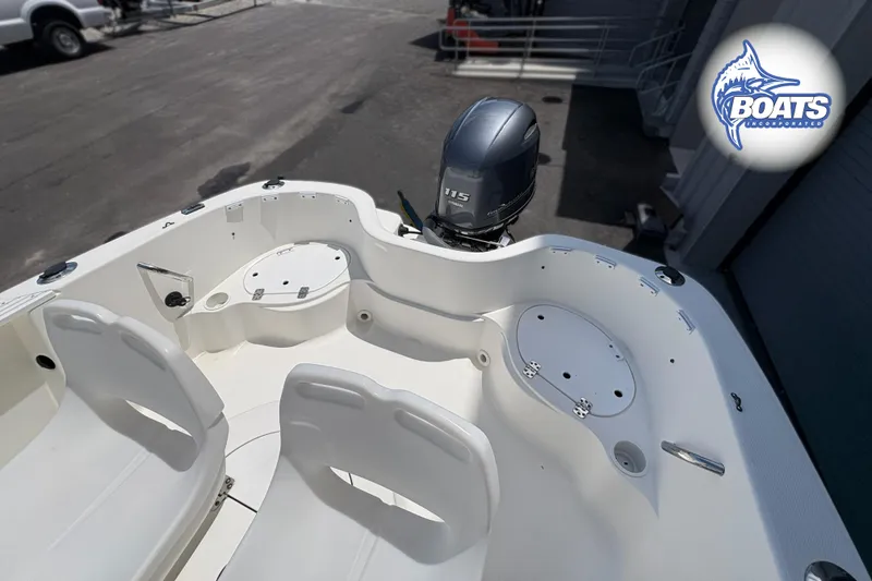 Slide: The Image of 2004 Wellcraft 180 Fisherman boat interior with seating and motor, displayed at Boats Incorporated. - 12